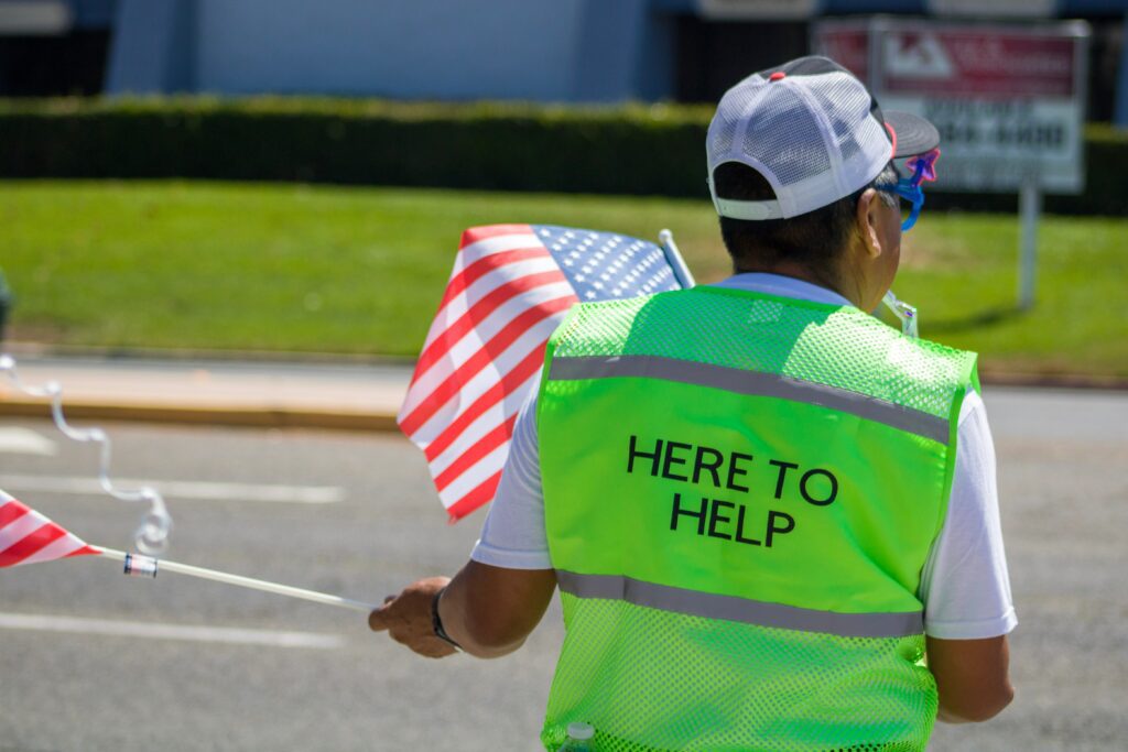 Photograph of man guiding traffic.