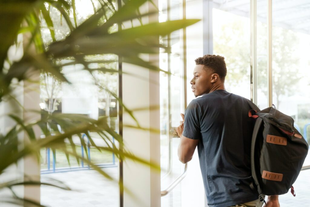 African American student looking out window. 