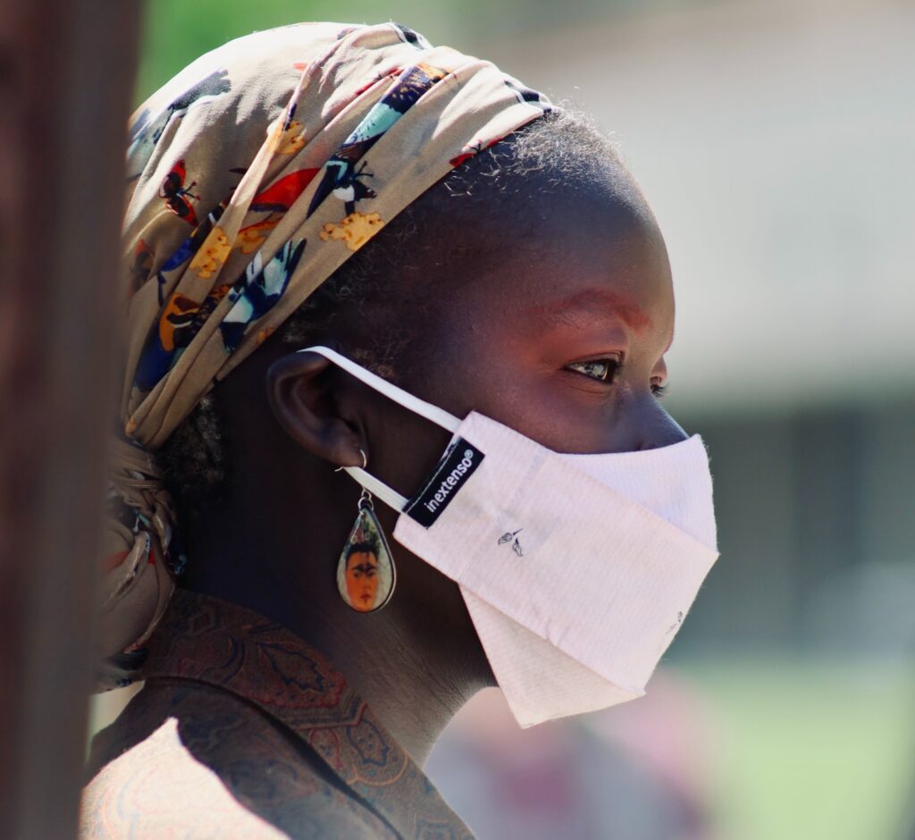 Black woman wearing mask. 