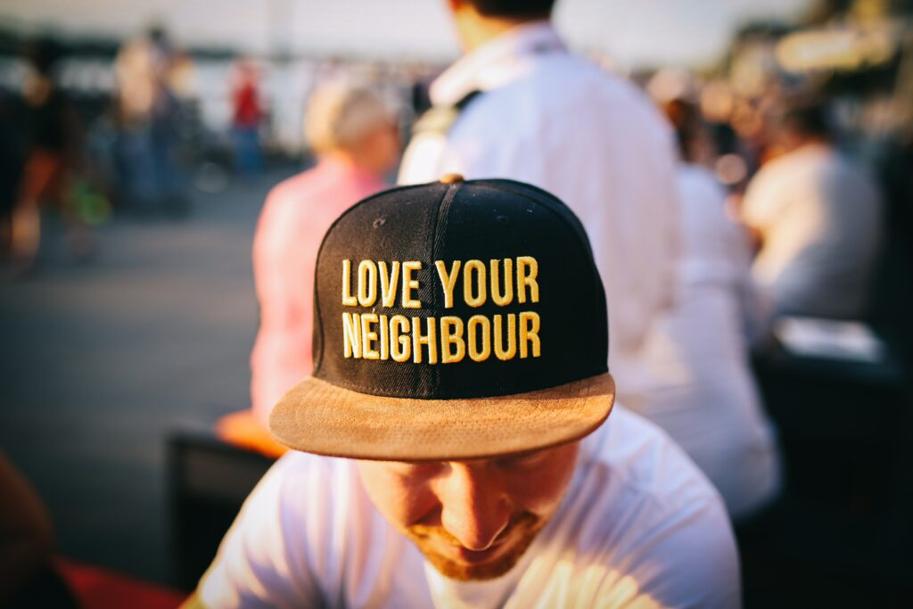 man wearing "love your neighborhood" hat"