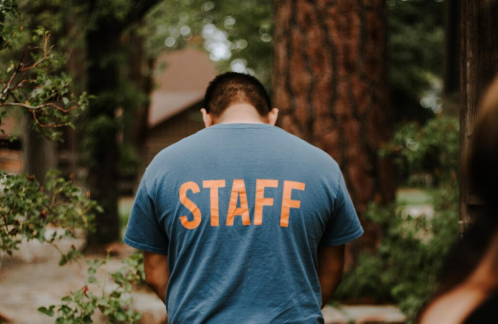 Man with back turned wearing staff shirt