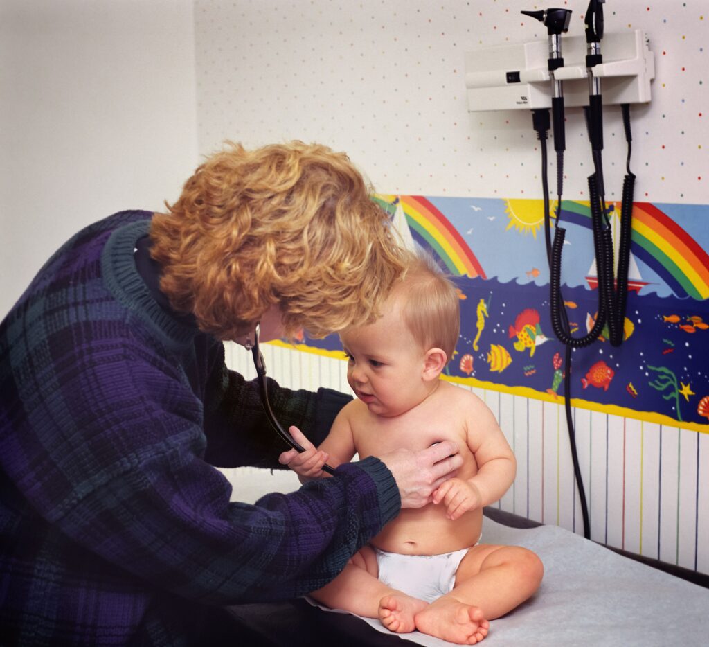 A paediatrician examining an infant at nine months of age