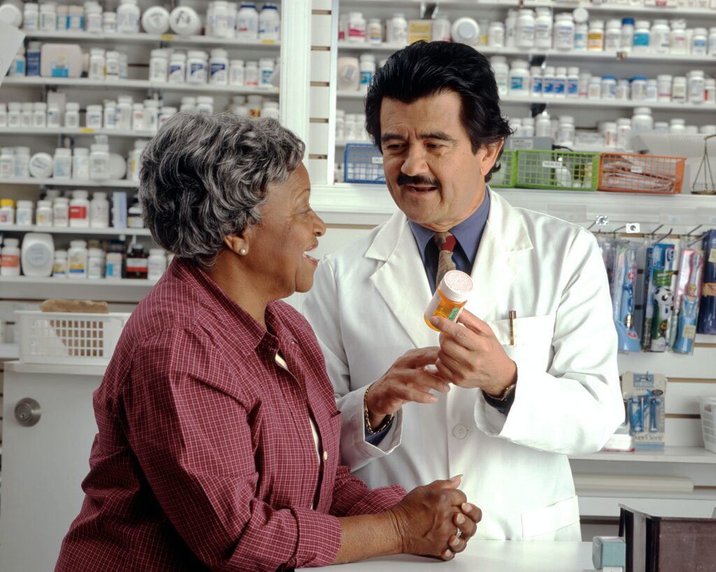 Woman Consults with Pharmacist.